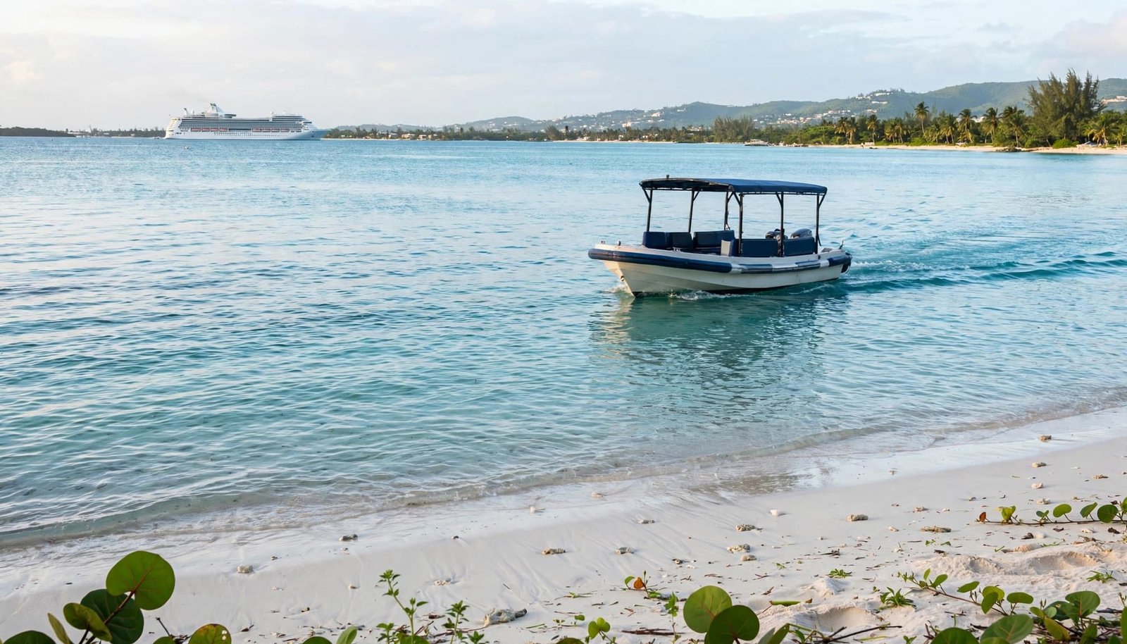 A tender boat heads toward shore from a cruise ship anchored off Grand Cayman.